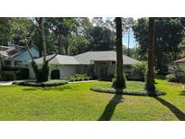 Charming single-story home boasts lush landscaping, a manicured lawn, and mature trees for enhanced curb appeal at 9129 Sw 193Rd Cir, Dunnellon, FL 34432