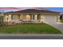 Charming single-story home with manicured lawn, paver driveway, and welcoming two-car garage at 10556 Sw 96Th Lane Rd, Ocala, FL 34481