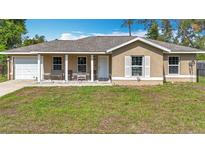 Charming one-story home featuring a covered porch, single car garage, and a well-maintained front lawn at 15640 Sw 48 Ave, Ocala, FL 34473