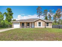 Charming one-story home featuring a covered porch, single car garage, and a well-maintained front lawn at 15640 Sw 48 Ave, Ocala, FL 34473