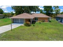 Charming single-story home with a well-maintained lawn and inviting curb appeal at 21425 Sw Plantation St, Dunnellon, FL 34431