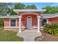 Charming single-story home featuring a welcoming front entrance with classic architectural columns at 3792 Sw 152Nd Ct, Ocala, FL 34481