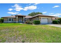 Charming single-story home with a manicured lawn, beautiful landscaping, and inviting curb appeal at 5420 Sw 86Th Ln, Ocala, FL 34476