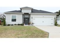 Charming single-Gathering home featuring a well-manicured lawn and a two-car garage at 5515 Se 91St St, Ocala, FL 34480