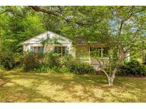 Charming home featuring blue shutters and inviting curb appeal with lush greenery surrounding the property at 608 Se 31St Ter, Ocala, FL 34471