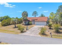 Charming single-story home with a tile roof, two-car garage, and a well-manicured front yard, nestled in a peaceful neighborhood at 347 Oak Lane Dr, Ocala, FL 34472