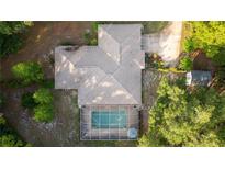 Aerial view of the home with a screened-in pool and mature trees at 3579 Sw Shorewood Dr, Dunnellon, FL 34431