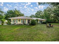 Charming home with a large front yard and decorative shutters at 3579 Sw Shorewood Dr, Dunnellon, FL 34431
