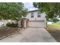 Charming two-story home featuring a two-car garage, arched entry, and well-maintained landscaping at 4624 Se 32Nd Pl, Ocala, FL 34480