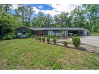 Charming single-story home with landscaped front yard, stone accents, and an inviting red front door at 4710 Se 30Th Ct, Ocala, FL 34480