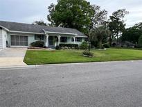 Charming single-story home featuring a well-maintained lawn and an inviting front porch at 8654 Sw 96Th St # D, Ocala, FL 34481