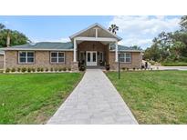 Charming single-story home featuring a stone facade, gabled entryway, and well-manicured front lawn at 170 Sw 80Th St, Ocala, FL 34476