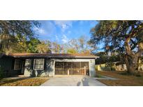 Charming single-story home features a screened-in garage and well-maintained front yard at 2151 Se 177Th Ave, Silver Springs, FL 34488