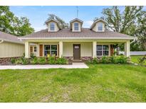 Charming single-story home featuring a welcoming porch, verdant lawn, and dormer windows for added curb appeal at 6600 Sw 109Th Ln, Ocala, FL 34476
