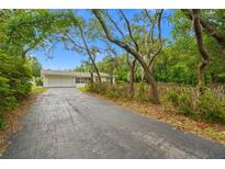 Long driveway leads to this charming single Gathering home nestled beneath beautiful mature trees at 8130 Sw 209Th Court Rd, Dunnellon, FL 34431