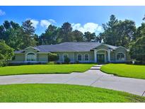 Charming single-story home with well-maintained lawn and lush landscaping creating a welcoming curb appeal at 7939 Se 12Th Cir, Ocala, FL 34480