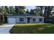 Charming single-story home with a well-maintained lawn and a classic, inviting facade at 267 Oak Lane Trak, Ocala, FL 34472