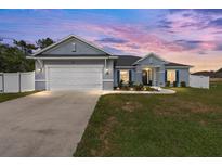 Charming single-story home featuring a two-car garage, manicured lawn, and inviting curb appeal at 9940 Sw 45Th Ave, Ocala, FL 34476