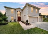 Two-story home with a two-car garage, well-manicured lawn, and inviting front entrance at 4620 Sw 42Nd St, Ocala, FL 34474
