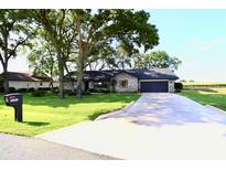 Charming single story brick home with well-manicured lawn and a long private driveway at 5351 Sw 80Th Pl, Ocala, FL 34476