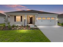 Charming single-story home with a well-manicured lawn, two car garage and inviting front entrance at 8783 Sw 69Th Place Rd, Ocala, FL 34481