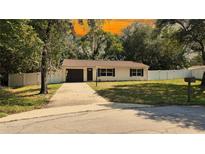 Charming single-story home featuring a neatly manicured lawn and long driveway at 9 Pine Radial Ct, Ocala, FL 34472
