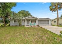 Charming single-story home featuring a well-maintained lawn and a welcoming front porch at 11091 Sw 76Th Ter, Ocala, FL 34476