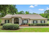 Charming single-story home with a well-manicured lawn, arched entryway, and inviting curb appeal at 1617 Se 29Th Ter, Ocala, FL 34471