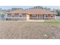 Charming single-story home with well-maintained landscaping and a welcoming front entrance at 7475 Se 105Th Pl, Belleview, FL 34420