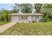 Charming single-story home with a well-manicured front yard and an attached garage at 8449 Sw 105Th Pl, Ocala, FL 34481