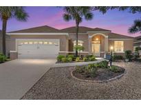 Charming single-story home with well-manicured landscaping, inviting entrance, and two-car garage at 9649 Sw 90Th St, Ocala, FL 34481