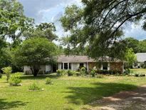 Charming single-story home surrounded by lush greenery and mature trees on a sun-drenched lot at 9850 Sw 191St Ave, Dunnellon, FL 34432