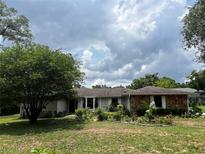 Charming single-story home with stone accents and mature landscaping in a well-maintained front yard at 9850 Sw 191St Ave, Dunnellon, FL 34432