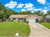 Charming single-story home featuring a well-manicured lawn, cozy curb appeal, and a convenient two-car garage at 10739 Se 44Th Ter, Belleview, FL 34420