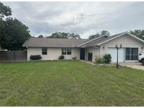 Charming single-story home featuring a well-maintained lawn and an attached garage at 10739 Se 44Th Ter, Belleview, FL 34420