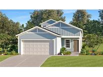 Charming single Gathering home with a two-car garage, light blue siding, a manicured lawn, and a paved driveway at 1139 Nw 44Th Court Rd, Ocala, FL 34482