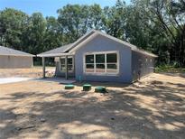 New construction, featuring a light blue exterior, multiple windows, and concrete driveway at 14319 Se 26Th Ter, Summerfield, FL 34491