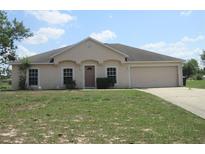 Charming single-story home with a well-maintained lawn and attached two-car garage at 1754 Sw 160Th Pl, Ocala, FL 34473