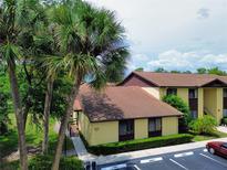 This cozy condo boasts lush landscaping, a convenient walkway, and ample parking, creating a welcoming and accessible exterior at 519 Fairways Cir # A, Ocala, FL 34472