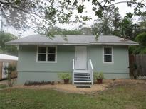 Charming single-story home featuring a landscaped front yard, inviting entrance, and neutral exterior color at 5949 Se 164Th Ct, Ocklawaha, FL 32179