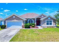 Charming single-story home with a well-manicured lawn and an attached two-car garage at 9677 Sw 56Th Cir, Ocala, FL 34476