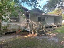 Quaint home featuring a covered porch, and an expansive yard perfect for landscaping at 1004 Ne 71St Ln, Ocala, FL 34479