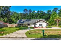 Charming single-story home featuring well-maintained lawn, stone accents and a long driveway at 2406 Se 40Th Street Rd, Ocala, FL 34480