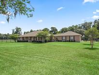 Charming single-story home featuring a manicured lawn, well-kept shrubbery and classic ranch-style architecture at 2540 Ne 120Th St, Anthony, FL 32617