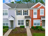 Charming townhome featuring a colorful exterior, well-manicured landscaping, and a welcoming entrance at 4412 Sw 49Th Ave, Ocala, FL 34474