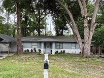 Charming single-story home with a well-maintained lawn and mature trees at 5549 Nw 64Th St, Ocala, FL 34482