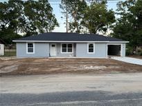 Charming single-story home featuring a new roof, light grey paint and an attached garage at 5787 Nw 58Th Ter, Ocala, FL 34482