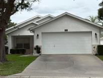 Charming single-story home featuring a two-car garage, well-maintained lawn, and classic landscaping at 9285 Sw 92Nd Place Rd, Ocala, FL 34481