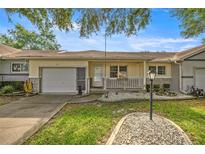 Charming single story home features a front porch, attached garage, and well maintained landscaping at 9667 Sw 94Th Ct # C, Ocala, FL 34481