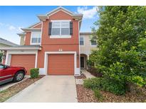 Two-story townhome with a single-car garage and well-maintained landscaping at 4927 Sw 45Th Cir, Ocala, FL 34474